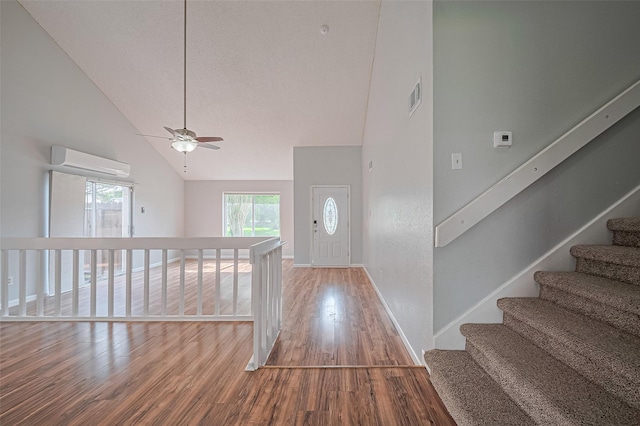 1806 Foxlake Dr, Houston, TX 77084 - foyer featuring a wall mounted AC, high vaulted ceiling, wood finished floors, ceiling fan, and baseboards