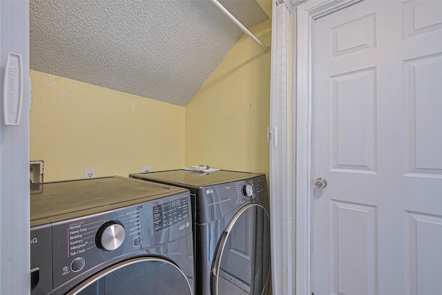 1806 Foxlake Dr, Houston, TX 77084 - laundry area with washing machine and clothes dryer and a textured ceiling