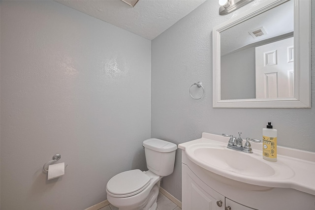 1806 Foxlake Dr, Houston, TX 77084 - half bath featuring vanity, toilet, tile patterned floors, a textured ceiling, and baseboards