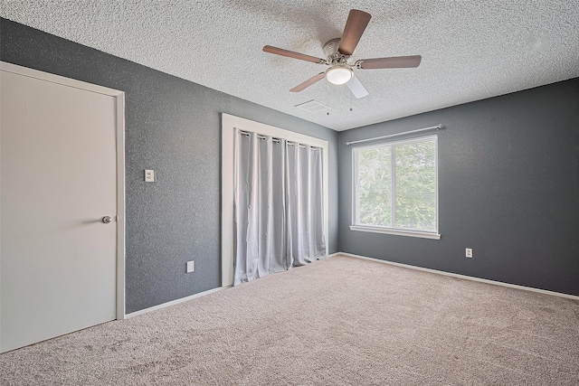 1806 Foxlake Dr, Houston, TX 77084 - unfurnished bedroom with a textured wall, a textured ceiling, carpet flooring, and a ceiling fan