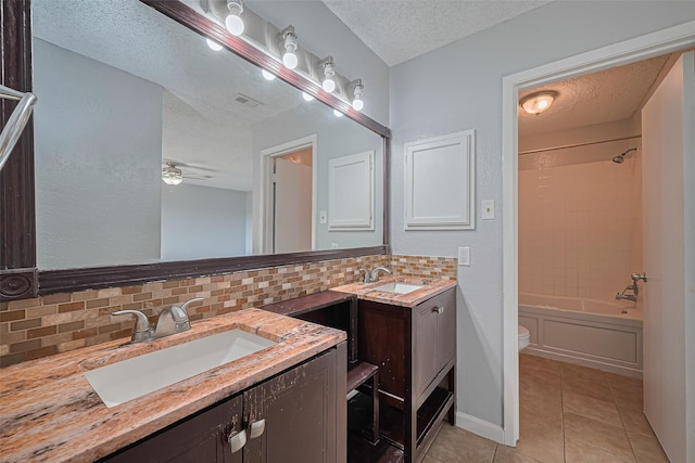 1806 Foxlake Dr, Houston, TX 77084 - full bath with a textured ceiling, backsplash, vanity, tile patterned floors, and toilet
