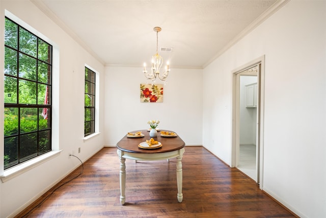 15 S Duskwood Pl, The Woodlands, TX 77381 - dining area with ornamental molding, a chandelier, wood finished floors, and baseboards