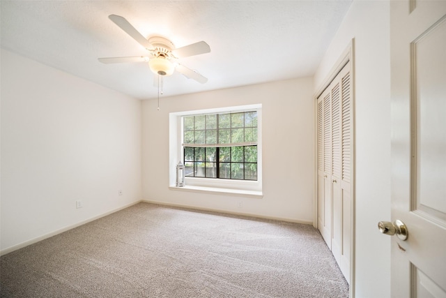 15 S Duskwood Pl, The Woodlands, TX 77381 - unfurnished bedroom featuring light carpet, a closet, baseboards, and ceiling fan