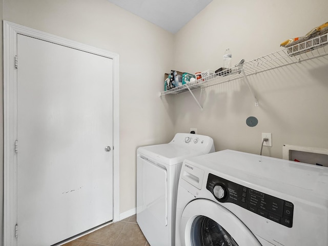 4015 Candle Cove Ct, Sugar Land, TX 77479 - laundry room featuring washer and clothes dryer, light tile patterned floors, and baseboards