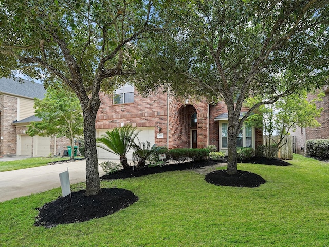 4015 Candle Cove Ct, Sugar Land, TX 77479 - view of front of home with an attached garage, concrete driveway, a front lawn, and brick siding