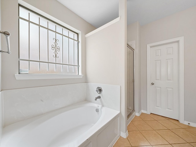 4015 Candle Cove Ct, Sugar Land, TX 77479 - bathroom with a bath, tile patterned floors, a shower stall, and baseboards