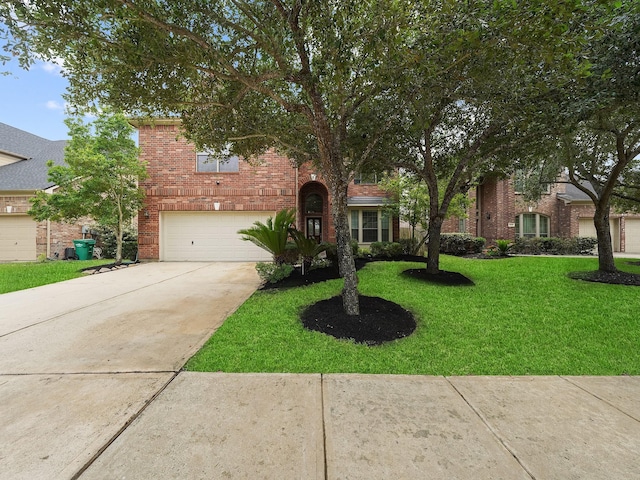 4015 Candle Cove Ct, Sugar Land, TX 77479 - view of front of home featuring driveway, a front yard, a garage, and brick siding