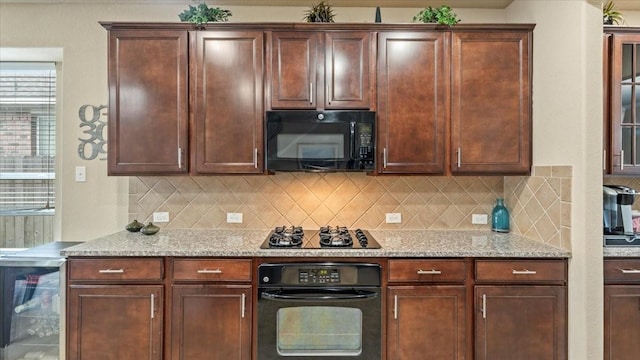 13822 Birney Point Ln, Houston, TX 77044 - kitchen featuring black appliances, tasteful backsplash, light stone counters, and beverage cooler