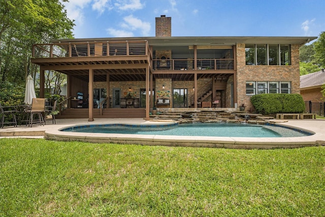 1927 E Lake Dr, Huntsville, TX 77340 - rear view of property featuring stairs, an outdoor pool, a lawn, brick siding, and a patio area