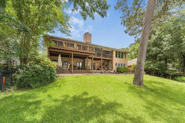 1927 E Lake Dr, Huntsville, TX 77340 - back of house featuring a chimney, a wooden deck, and brick siding