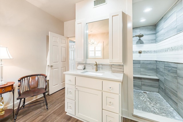 1927 E Lake Dr, Huntsville, TX 77340 - full bathroom featuring tiled shower, vanity, wood finished floors, and recessed lighting