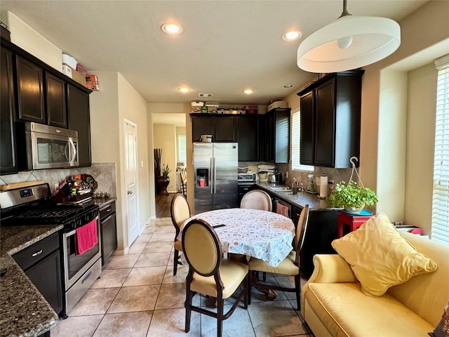 1315 Maple Ace Dr, Katy, TX 77493 - kitchen featuring stainless steel appliances, tasteful backsplash, recessed lighting, dark stone countertops, and a sink