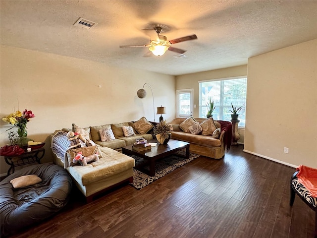 1315 Maple Ace Dr, Katy, TX 77493 - living room featuring wood finished floors, a textured ceiling, a ceiling fan, and baseboards