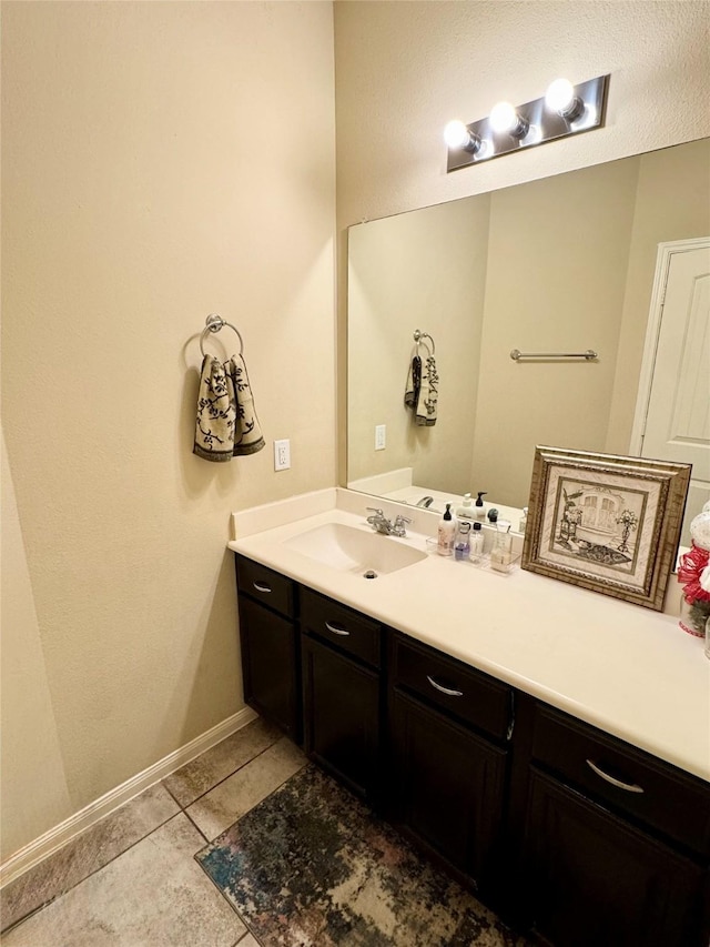 1315 Maple Ace Dr, Katy, TX 77493 - bathroom featuring vanity, tile patterned flooring, and baseboards