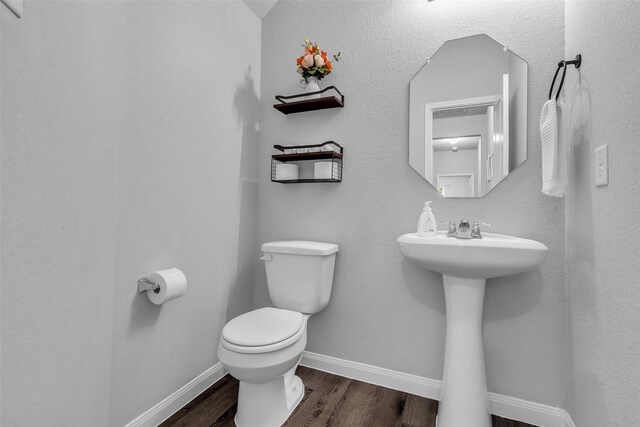 25424 Grotto Falls Ln, Porter, TX 77365 - bathroom with toilet, wood finished floors, and baseboards