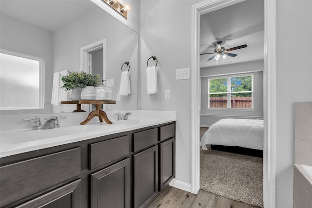 25424 Grotto Falls Ln, Porter, TX 77365 - ensuite bathroom with double vanity, wood finished floors, and ceiling fan