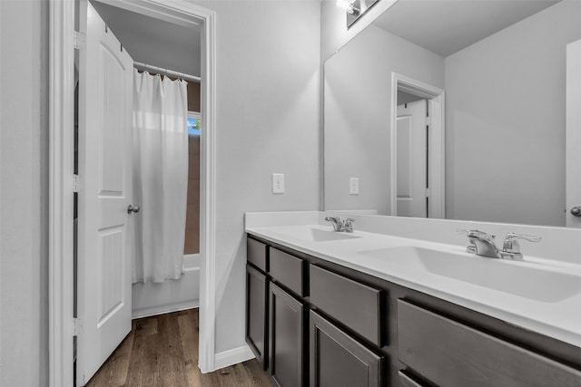 25424 Grotto Falls Ln, Porter, TX 77365 - full bathroom with double vanity, wood finished floors, shower / tub combo with curtain, and baseboards