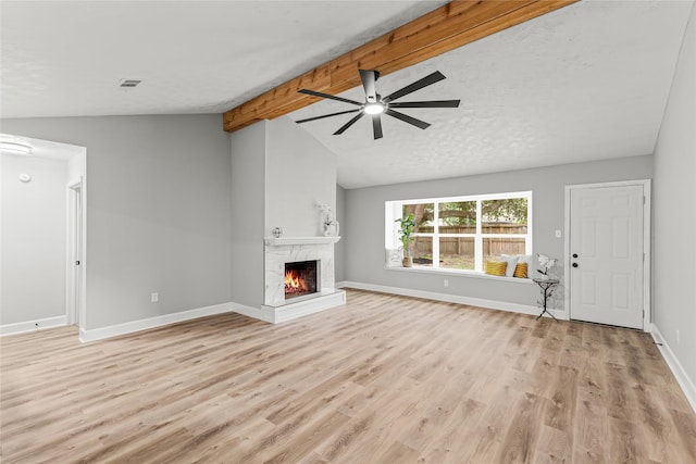 10503 Long River Dr, Sugar Land, TX 77498 - unfurnished living room with ceiling fan, light wood-style flooring, a warm lit fireplace, and baseboards