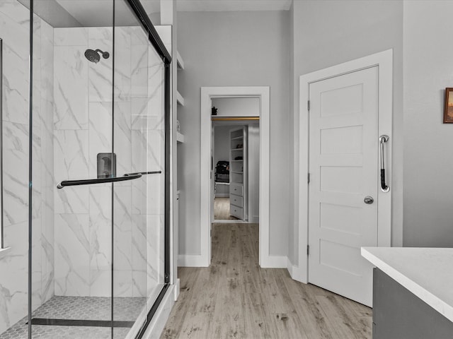 2965 Rustic Pier Ln, League City, TX 77573 - full bathroom featuring a marble finish shower, wood finished floors, baseboards, and vanity