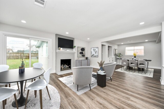 9414 Colleen Rd, Houston, TX 77080 - living room featuring light wood-style flooring, a fireplace with raised hearth, recessed lighting, and baseboards