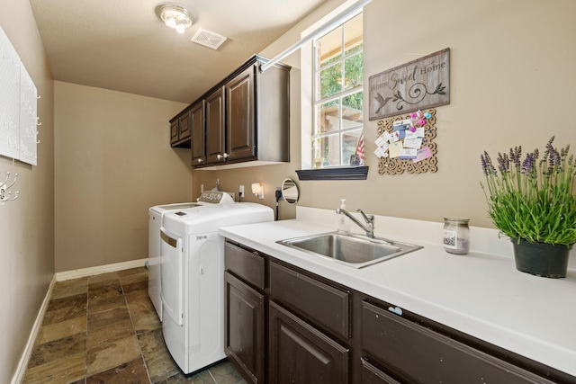 1915 Landon Point Cir, Katy, TX 77450 - laundry room featuring cabinet space, washing machine and clothes dryer, stone tile floors, and baseboards