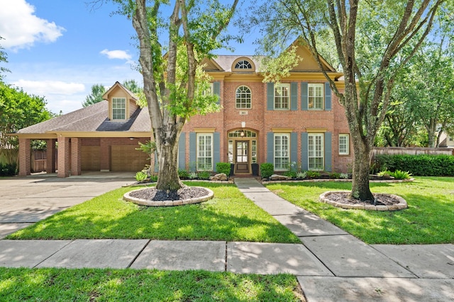 1915 Landon Point Cir, Katy, TX 77450 - colonial-style house featuring a garage, driveway, brick siding, and french doors