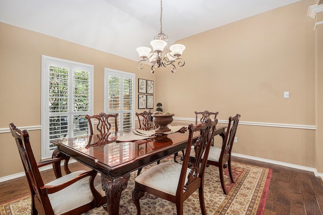 10235 Shipmans Landing Dr, Missouri City, TX 77459 - dining room featuring dark wood-style floors, a chandelier, vaulted ceiling, and baseboards