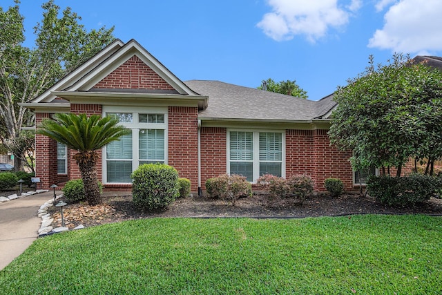 10235 Shipmans Landing Dr, Missouri City, TX 77459 - view of front facade with brick siding, a front yard, and roof with shingles