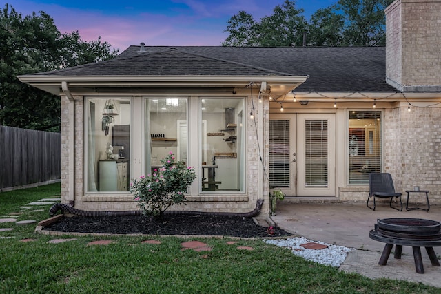 907 Eva Dr, Katy, TX 77493 - back of property featuring a shingled roof, a patio area, a chimney, and brick siding
