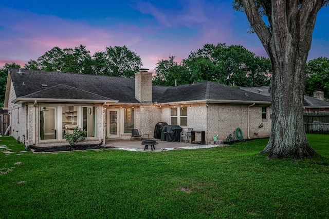 907 Eva Dr, Katy, TX 77493 - back of house with a patio area, brick siding, a chimney, and a shingled roof