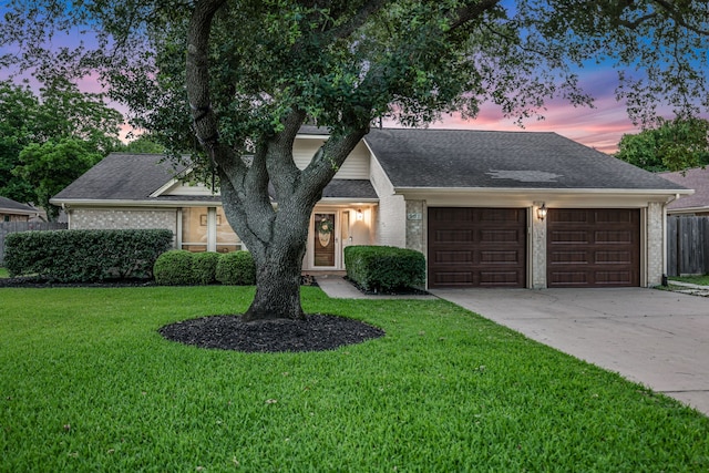 907 Eva Dr, Katy, TX 77493 - view of front of home featuring an attached garage, driveway, brick siding, and a shingled roof