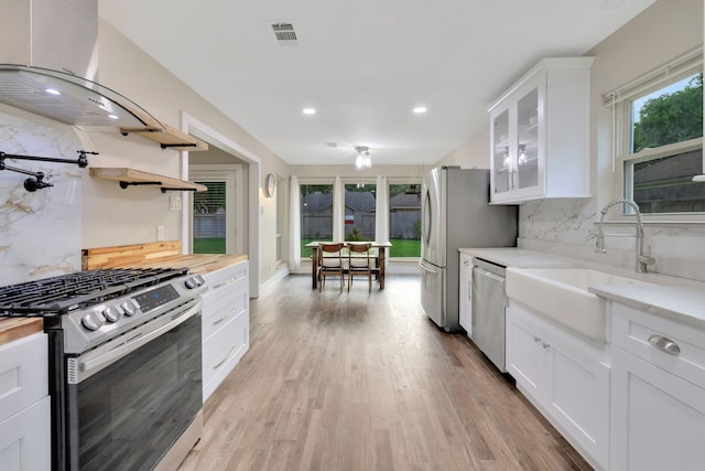 907 Eva Dr, Katy, TX 77493 - kitchen with stainless steel appliances, decorative backsplash, recessed lighting, white cabinetry, and a sink