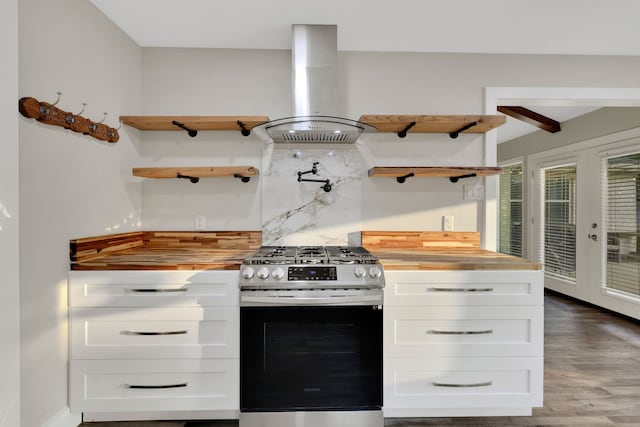 907 Eva Dr, Katy, TX 77493 - kitchen with stainless steel gas stove, island range hood, open shelves, and butcher block countertops