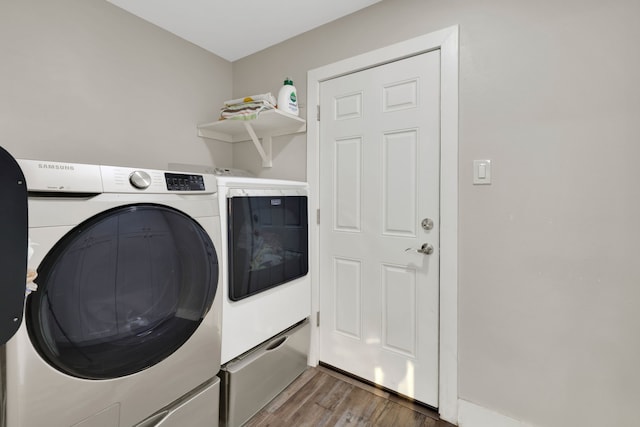 907 Eva Dr, Katy, TX 77493 - laundry room with separate washer and dryer and wood finished floors