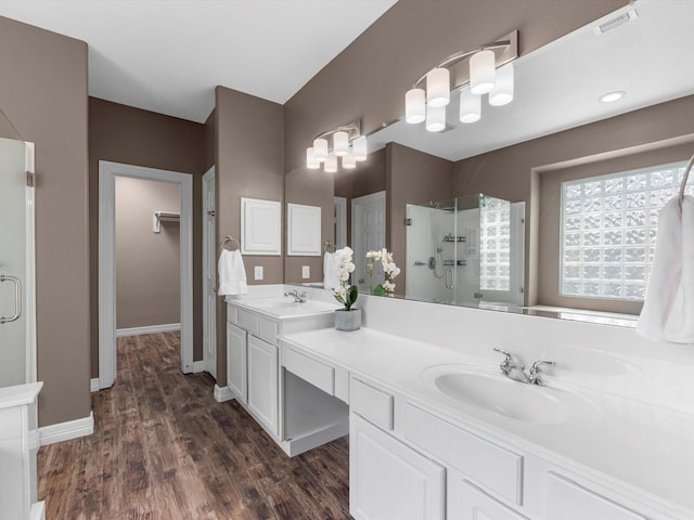 25169 Nutley Cir, Porter, TX 77365 - full bath featuring a shower stall, double vanity, wood finished floors, baseboards, and a closet