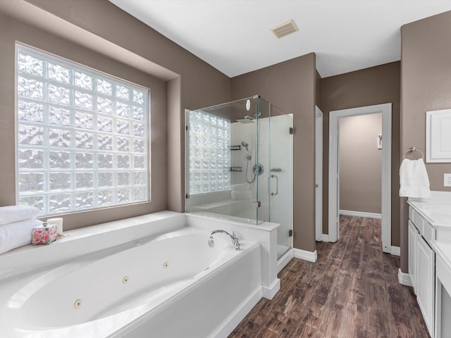 25169 Nutley Cir, Porter, TX 77365 - bathroom with a shower stall, a tub with jets, vanity, wood finished floors, and baseboards