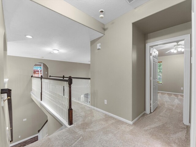 25169 Nutley Cir, Porter, TX 77365 - hallway featuring carpet flooring, baseboards, and arched walkways