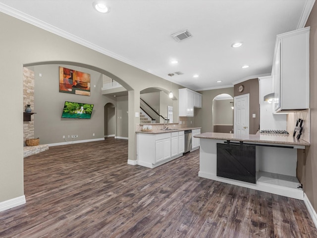 25169 Nutley Cir, Porter, TX 77365 - kitchen with stainless steel appliances, a sink, arched walkways, crown molding, and dark wood finished floors