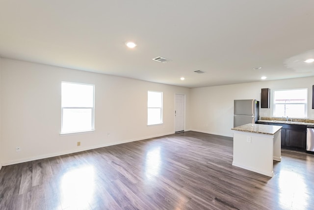 2722 Stallings Dr, Houston, TX 77088 - kitchen featuring freestanding refrigerator, healthy amount of natural light, a kitchen island, stainless steel dishwasher, and recessed lighting