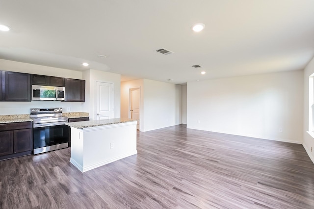 2722 Stallings Dr, Houston, TX 77088 - kitchen with appliances with stainless steel finishes, wood finished floors, recessed lighting, a center island, and open floor plan