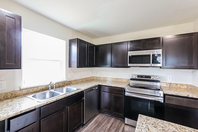 2722 Stallings Dr, Houston, TX 77088 - kitchen featuring appliances with stainless steel finishes, a sink, wood finished floors, and dark brown cabinetry