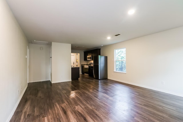 435 Connecticut St, Houston, TX 77029 - unfurnished living room with dark wood-style flooring, baseboards, and recessed lighting