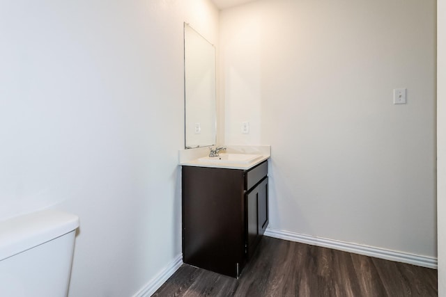 435 Connecticut St, Houston, TX 77029 - half bathroom with wood finished floors, vanity, toilet, and baseboards