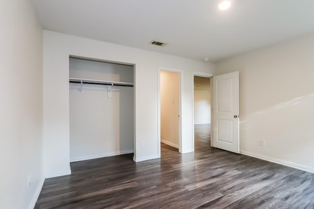 435 Connecticut St, Houston, TX 77029 - unfurnished bedroom with dark wood-type flooring, a closet, and baseboards