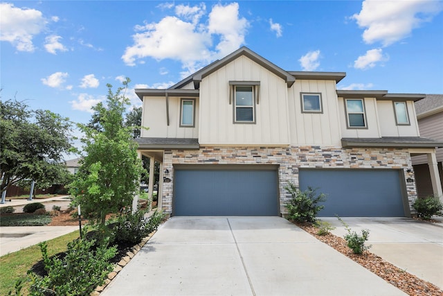 4050 Champlain Way, Rosharon, TX 77583 - view of front of house featuring concrete driveway, board and batten siding, a garage, and stone siding