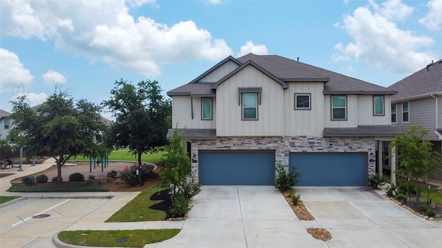 4050 Champlain Way, Rosharon, TX 77583 - view of front of property with board and batten siding, an attached garage, concrete driveway, and stone siding