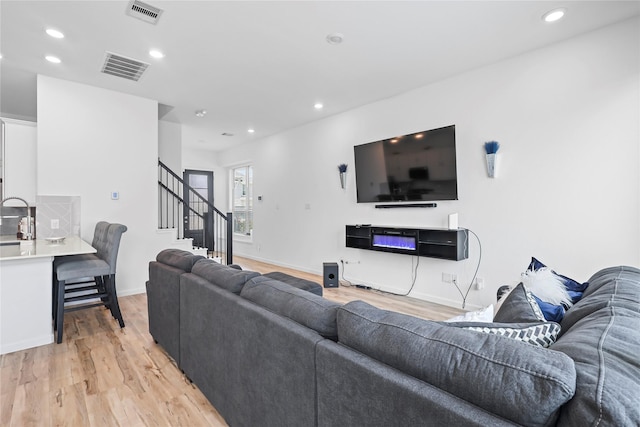 4050 Champlain Way, Rosharon, TX 77583 - living room featuring light wood finished floors, recessed lighting, stairs, and baseboards