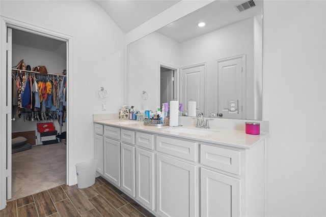 4050 Champlain Way, Rosharon, TX 77583 - bathroom with double vanity, wood finished floors, and a spacious closet