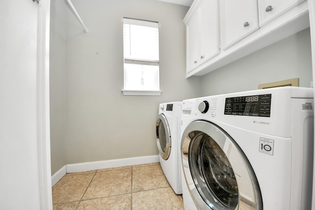 3306 Candlelon Dr, Spring, TX 77388 - laundry area with cabinet space, baseboards, washing machine and clothes dryer, and light tile patterned flooring