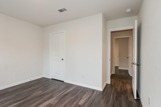 9721 Stedman St, Houston, TX 77029 - empty room with dark wood-style floors, baseboards, and a smoke detector